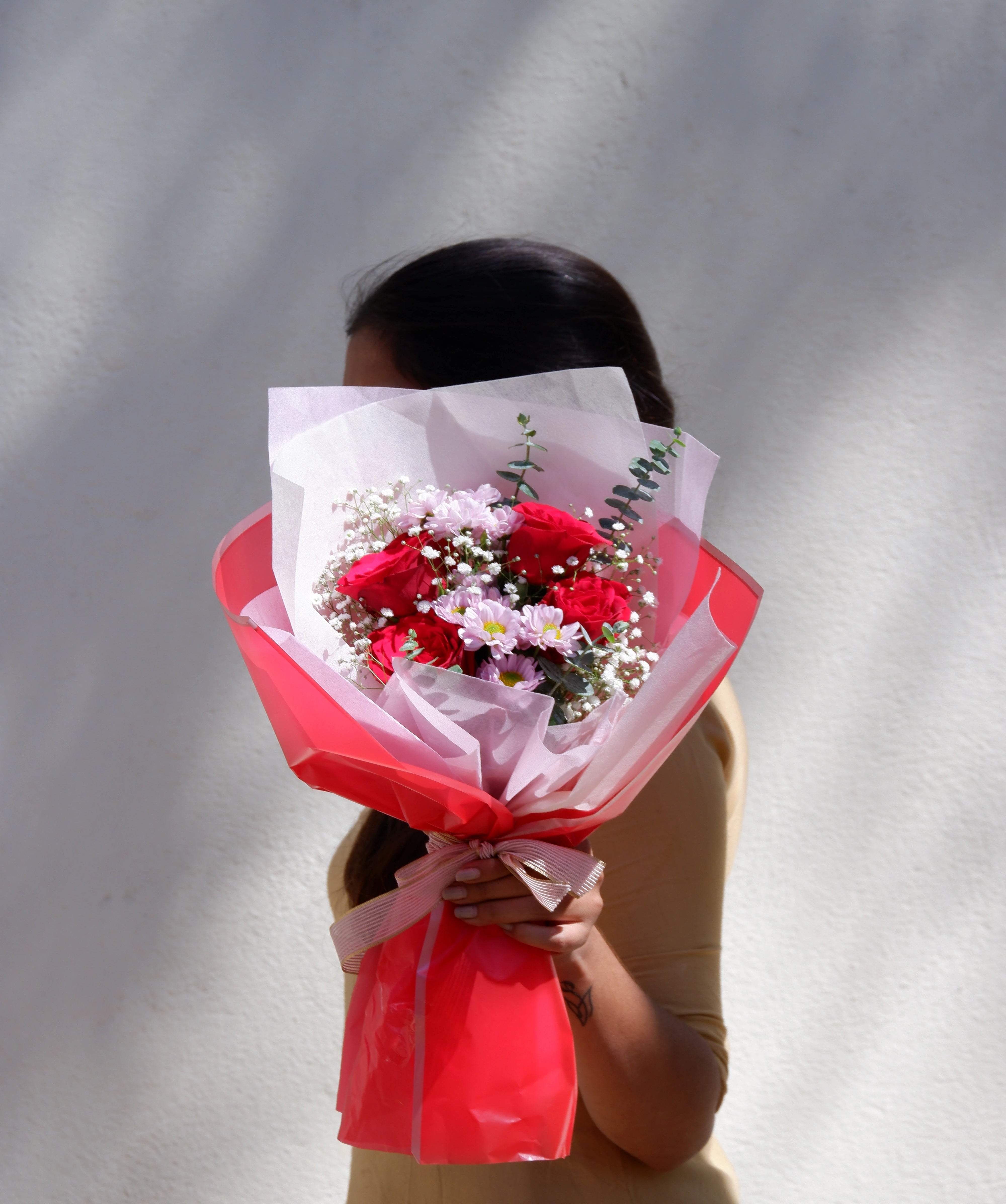 A bouquet of love with red roses and pink santini